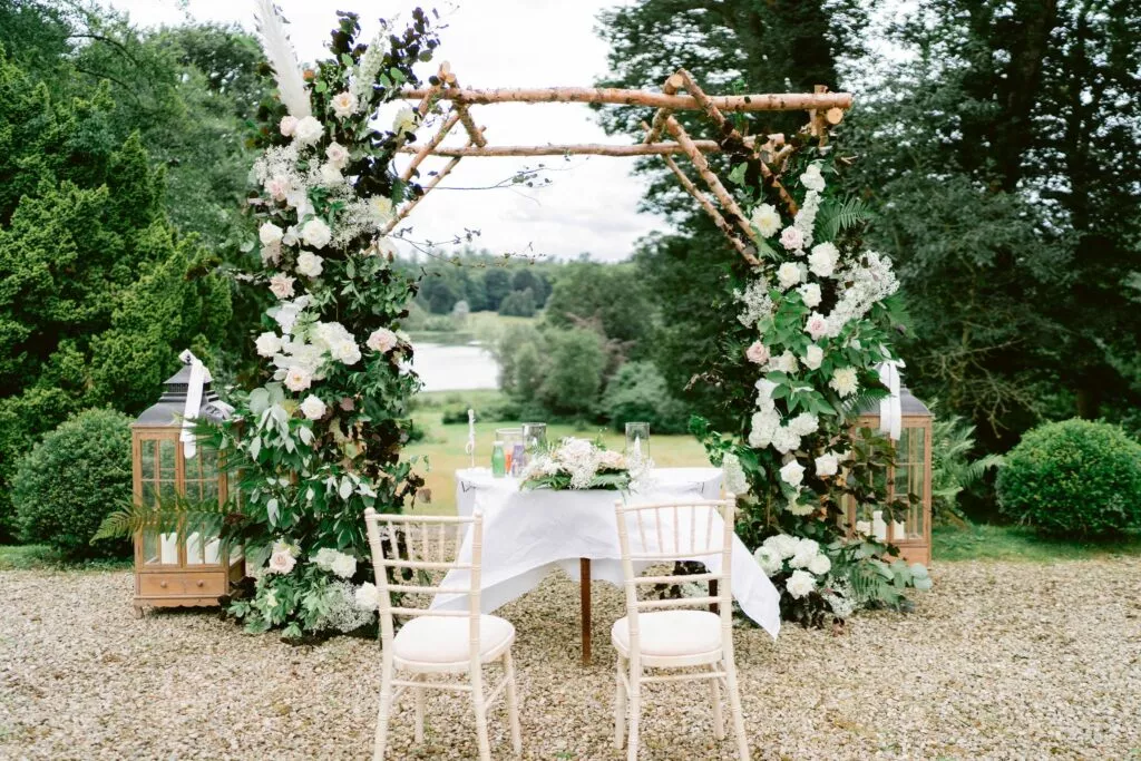Outdoor wedding ceremony at Hilton Park with flower arch